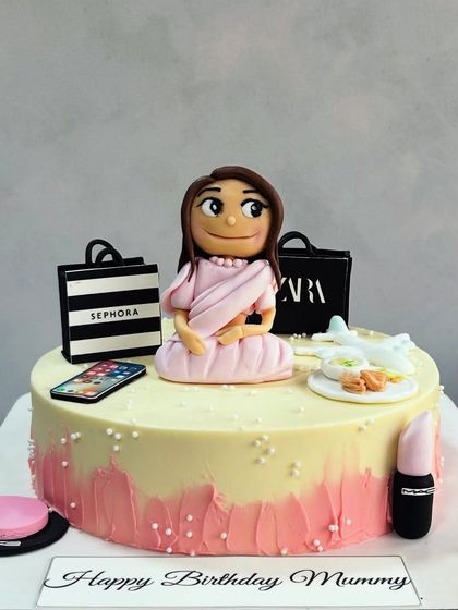 A cake that celebrates everything Mom loves! This custom design features her favorite things: shopping at Zara and Sephora, her phone, and a plate of her favorite food.