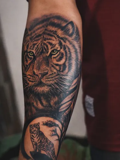 A tiger tattoo represents silent strength and courage. For this piece, I focused on creating hyper-realistic fur texture and piercing green eyes that hold your gaze. The deep, layered shading gives it a powerful 3D effect, making it a bold statement on the forearm.