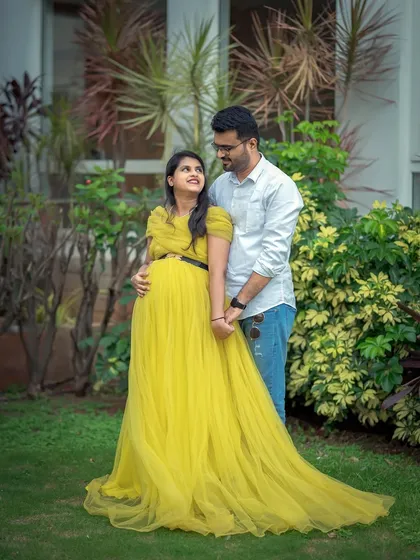 A sweet and happy couple's maternity photo. The yellow gown brings a sense of warmth and joy to this beautiful moment.