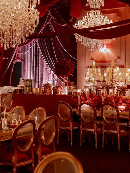 We drenched this Sangeet night in opulent shades of red, using rich velvet draping and dramatic lighting to create a royal, majestic ambiance. The combination of crystal chandeliers and hundreds of candles provided a warm, intimate glow for an evening of celebration.