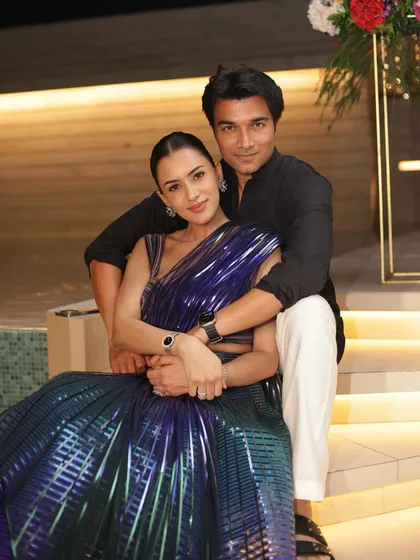 A romantic couple portrait. Her clean glam complements his classic black outfit perfectly, creating a timeless and elegant image.