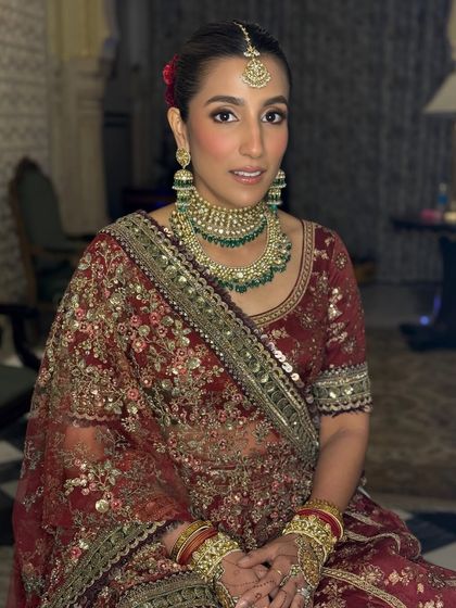 This seated portrait shows the intricate details of the bride's makeup and jewelry. I used a soft contour and highlight to define her features, ensuring she looked perfect from every angle.