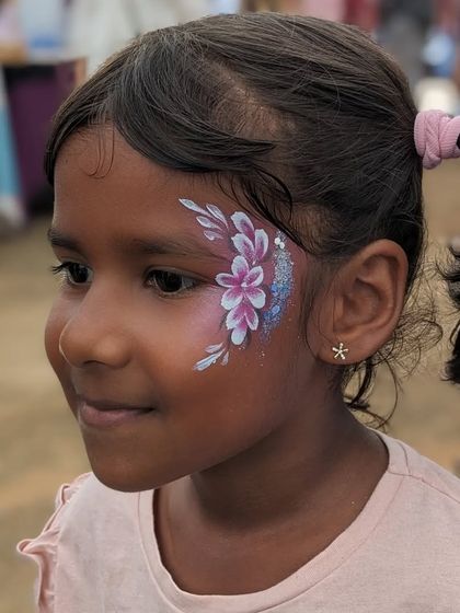 A delicate floral design in shades of purple, accented with blue glitter for a bit of sparkle.