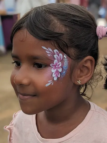 A delicate floral design in shades of purple, accented with blue glitter for a bit of sparkle.