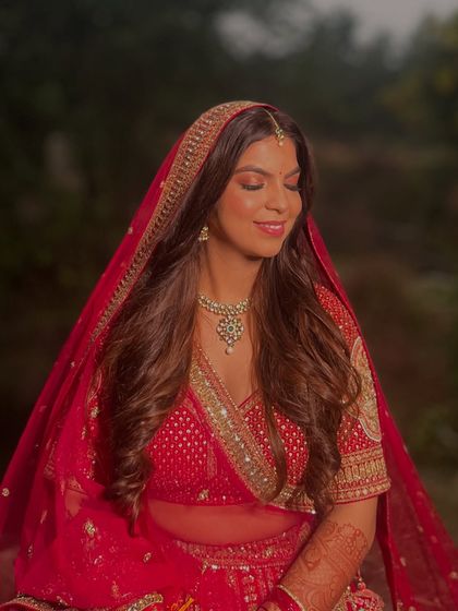 A beautiful shot of the bride under her veil. The makeup is soft and romantic, creating a dreamy and ethereal bridal look.