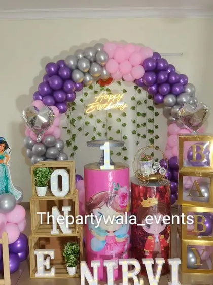 A lovely princess theme with wooden "ONE" blocks and "BABY" boxes. The mix of purple, pink, and silver balloons with princess cutouts is perfect for a first birthday celebration.