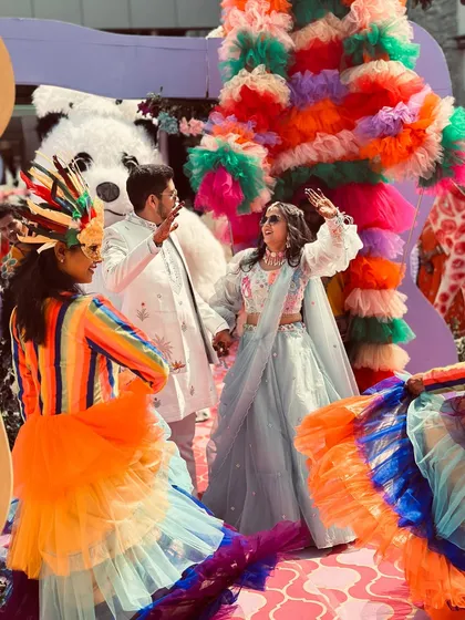 The couple's entry at their wedding carnival, complete with colorful performers. I help orchestrate these unique moments to make your celebration stand out.