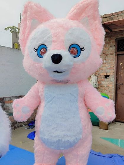 A close-up shot of the custom-designed pink fox character mascot. The bright colors and large, friendly eyes make it very appealing for kids' events.