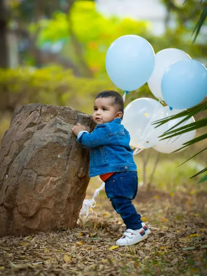 Exploring the park with his balloons in tow. These action shots are full of life and energy.
