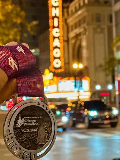 The reward for months of dedication. Holding the Chicago Marathon medal against the city's iconic backdrop is a reminder of what's possible. This is the kind of unforgettable moment we train for.