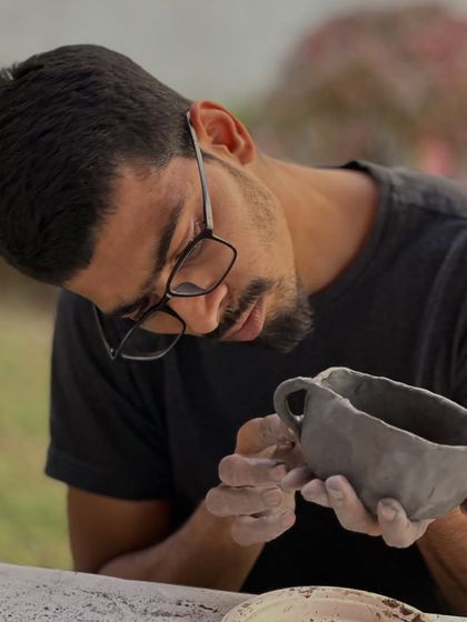 The intense focus of a scientist applied to a new craft. Here, a participant from the Tata Memorial Centre workshop carefully refines the shape of his hand-built mug.