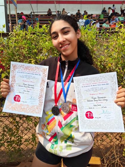 Fiyan showcasing her medals and certificates, a testament to her hard work and dedication in the U-16 category.