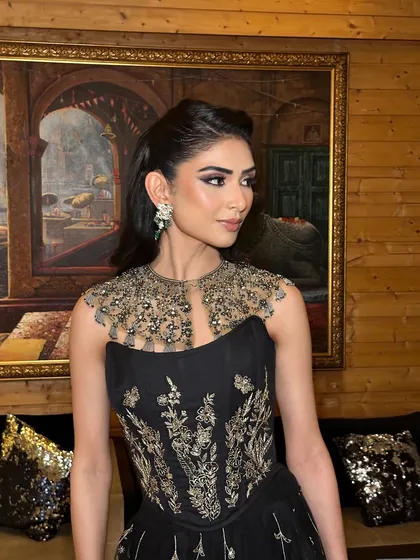 This shot captures the full effect of the makeup with the intricate, embellished gown. The look is powerful and sophisticated, ideal for a formal event or wedding reception.