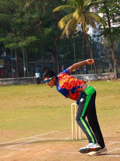 A spinner tossing the ball up during a practice game, working on his variations.