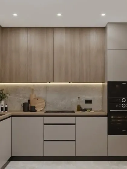 A compact L-shaped kitchen that feels warm and modern. We paired light grey lower cabinets with wood-grain upper cabinets and integrated a full-height unit for the oven, ensuring a clean look and efficient use of space.