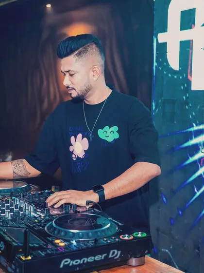 A shot of me mixing at a club, focused on the craft. The caption reflects my dedication to being an artist.