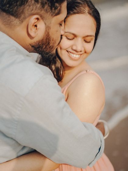 A close-up portrait capturing a gentle kiss and a genuine smile. These are the authentic moments I strive to document.