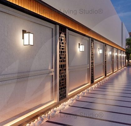 An elegant outdoor lobby connecting the front lawn and backyard of a luxurious villa. The design features a long, illuminated walkway with decorative wall panels and classic lighting fixtures.