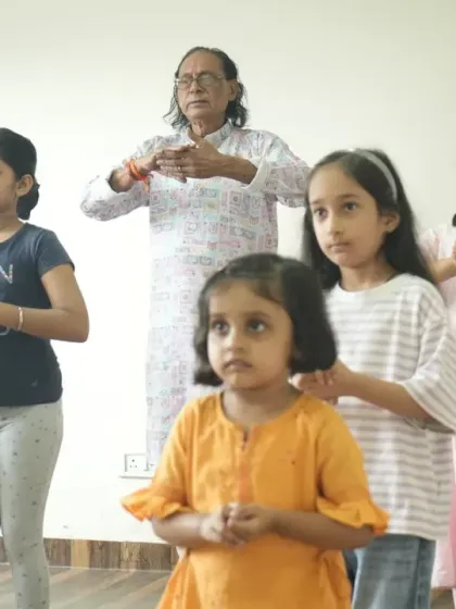 The foundation of our teaching lies in the sacred Guru-Shishya tradition. Here, one of our senior gurus guides our youngest students as they learn their first mudras, ensuring that the art form is passed on with care and respect.