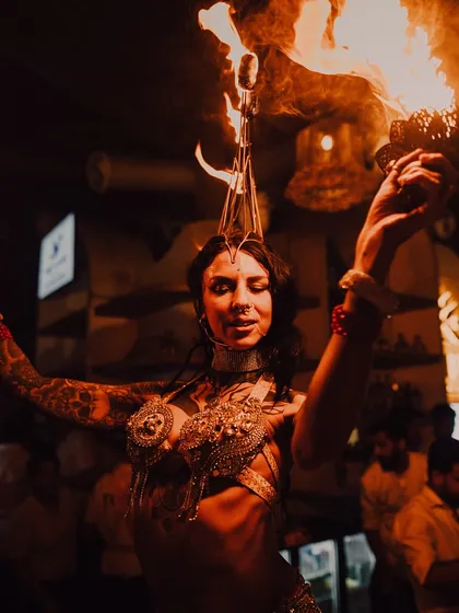 Fusing the fluid movements of belly dance with the danger of fire. This performance showcases a custom fire headdress, where the flames dance just inches from the artist, requiring immense focus and skill.
