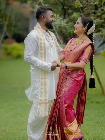A duplicate of image 4, showing a happy couple holding hands and smiling at each other in a garden.