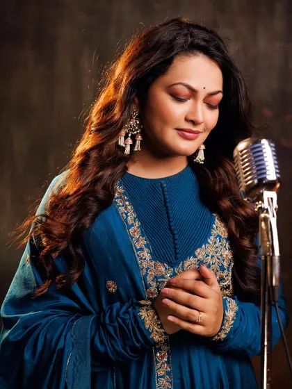 A vintage-style shot with a classic microphone, where the elegant Anarkali adds to the nostalgic mood.