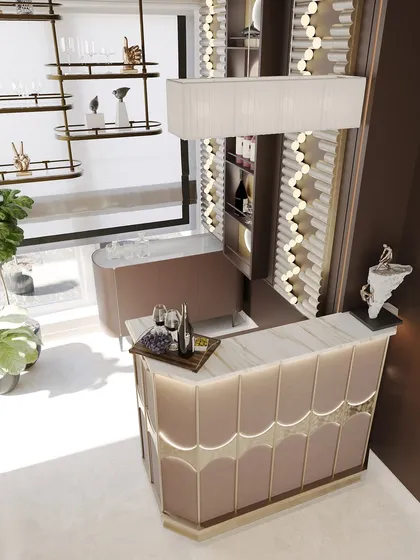 An overhead view of the bar, showcasing the elegant, curved counter with custom paneling and integrated lighting. The palette is a soft, inviting pinkish beige.