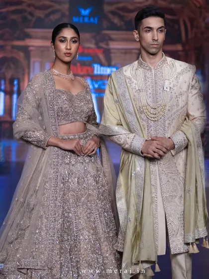 This is the embodiment of classic elegance on the runway. I crafted this off-white raw silk sherwani with exquisite zardozi hand embroidery and paired it with a traditional pearl necklace to create a look of timeless, regal sophistication.