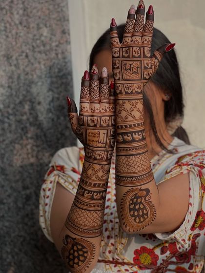 A beautiful back-of-hand design with intricate grids and personalized animal motifs.