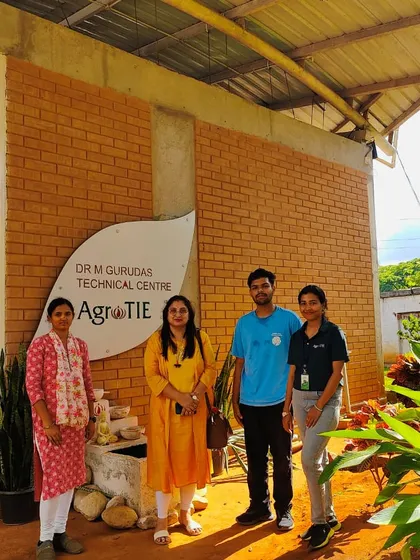 Members of our team and visitors standing in front of the Dr. M Gurudas Technical Centre at AgroTIE. This is the hub of our training and innovation.