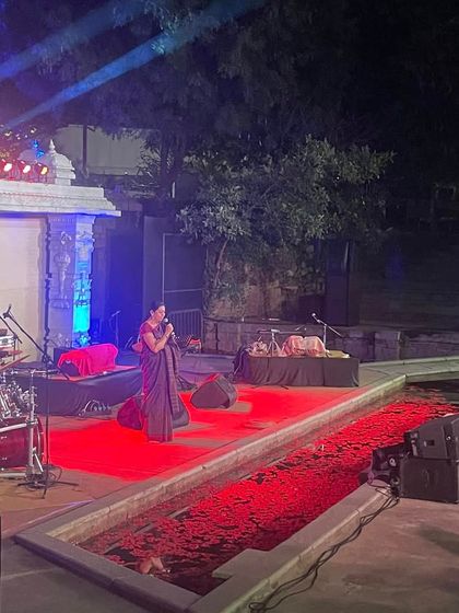 Addressing the audience at the Soma Festival, held in a beautiful amphitheater at the Shankara Foundation. The stage, with its dramatic lighting and water feature, made it a memorable evening.