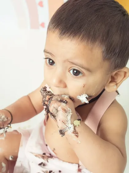 A close-up of the messy, delicious fun of a cake smash. This is what pure indulgence looks like!