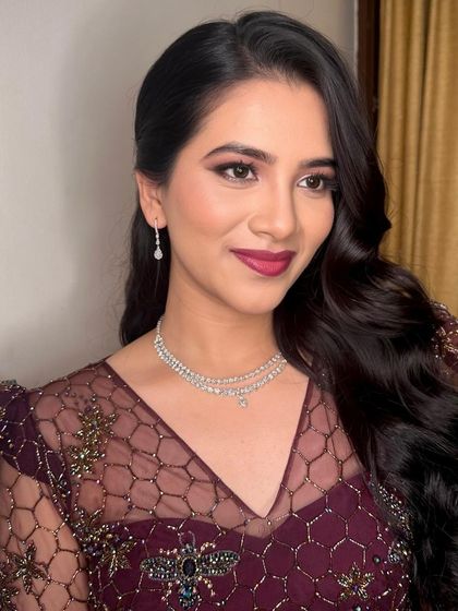 A glamorous cocktail look. I created a bold berry lip and a soft smokey eye to complement her deep plum gown, perfect for an evening of celebration.