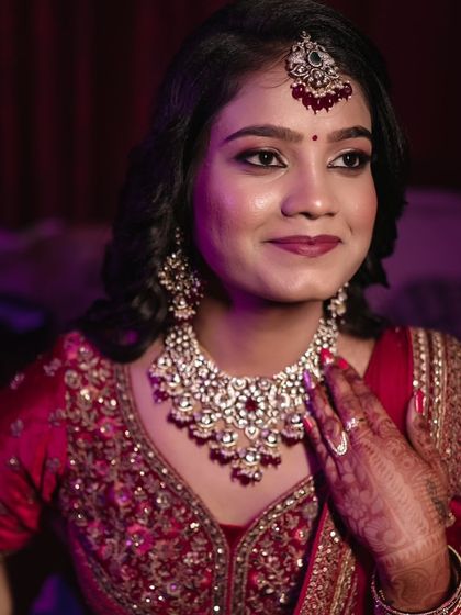 A close-up of the stunning polki and ruby set. The intricate craftsmanship and the vibrant red beads make this a truly special piece for any bride.