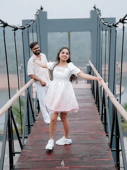 A happy, carefree pose on the bridge, with her arms outstretched as if embracing the moment.