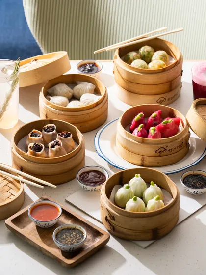 A bright and airy photo of a dim sum spread. This style is perfect for brunch menus or restaurants with a fresh, modern interior.