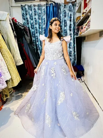 A full view of my popular lavender gown. The delicate floral applique and the off-shoulder design make it a modern fairy-tale dress, available for rent or purchase.