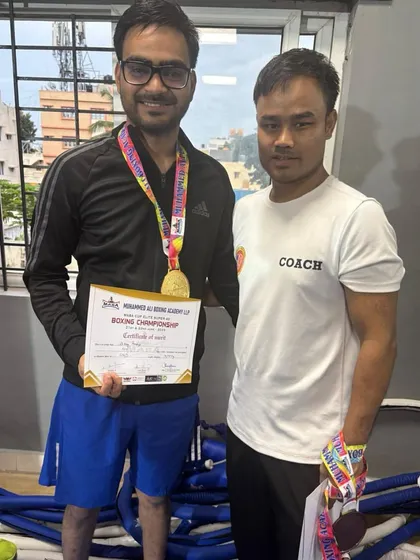 I don't just train you, I build champions. Here I am with one of my students after he won gold at the Super 40 Elite Men Boxing Championship. Hard work and dedication always pay off.