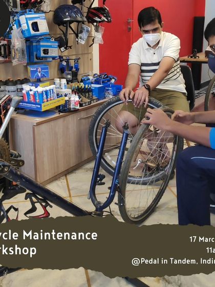 Participants in a workshop learning how to correctly remove and fit a wheel. This is a fundamental skill for fixing flats or transporting your bike.