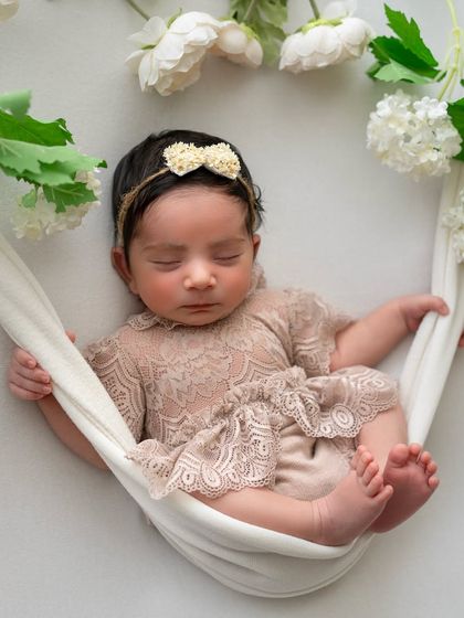 This is the final result of our hammock setup. The baby appears to be peacefully floating among flowers, a beautiful illusion we create using safe, hands-on techniques and a little editing magic.