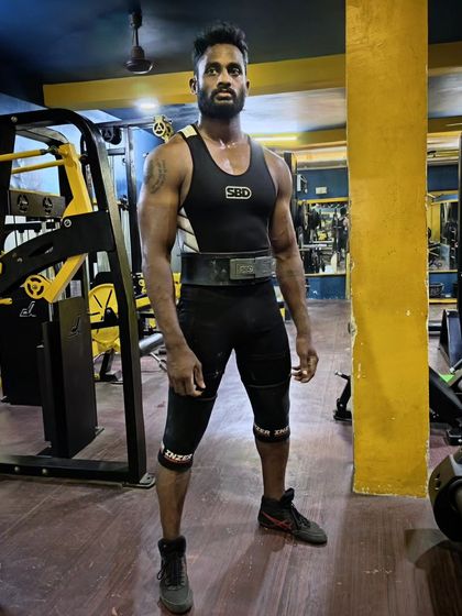 The look of a focused powerlifter. Geared up and ready to step onto the platform.