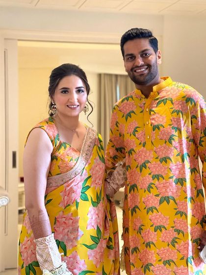 The happy couple in matching yellow outfits for their Haldi. The bride's braided hairstyle is both beautiful and practical for the event.