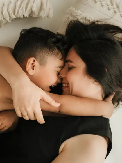 An overhead shot of a mother and son cuddling and laughing. These are the precious, silly moments I love to capture in a mother and son photoshoot.