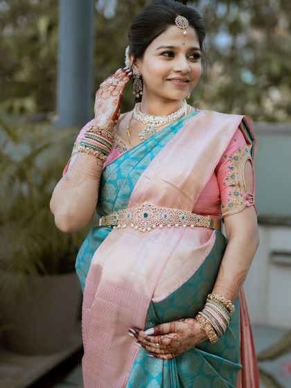 Our gorgeous client Monika, draped in a beautiful pastel pink and blue Kanchipuram silk for her baby shower. The soft colors are perfect for celebrating new life.