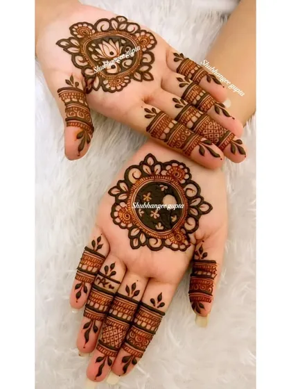 A minimal design perfect for Karwa Chauth or any festival. Each hand has a different central mandala, one with a lotus and one with a simple geometric pattern, showing that simple can still be beautiful.