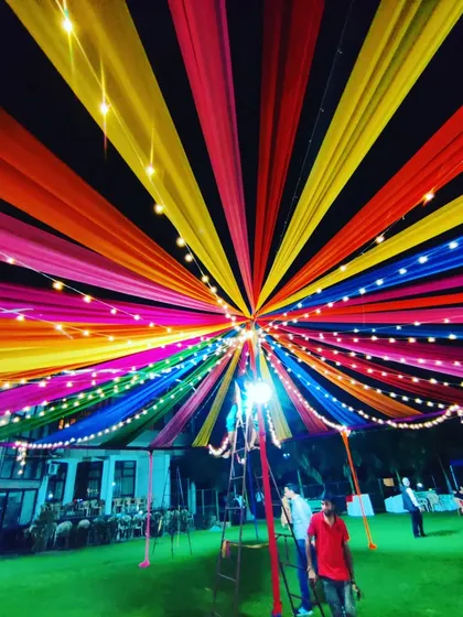 The colorful canopy seen from a different perspective, highlighting the structure and the way the lights illuminate the entire area for a night event.