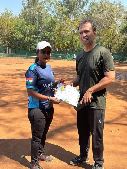 A coach presenting a medal at our Amateur Tournament. These events are designed for players to learn, compete, and grow in a supportive environment.