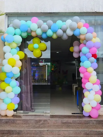 A beautiful pastel-colored balloon arch welcoming guests to the baby celebration. The soft colors are perfect for creating a gentle and happy ambiance.