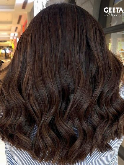 A rich, chocolate brown global colour with soft waves, giving the hair a healthy and voluminous appearance.