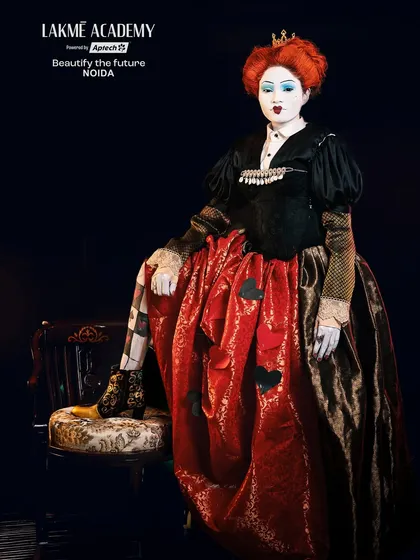 A full-length pose of the Queen of Hearts on her throne. This image showcases the complete character design, from the makeup to the custom-designed costume.